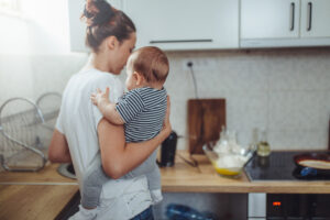 Mother with baby in kitchen